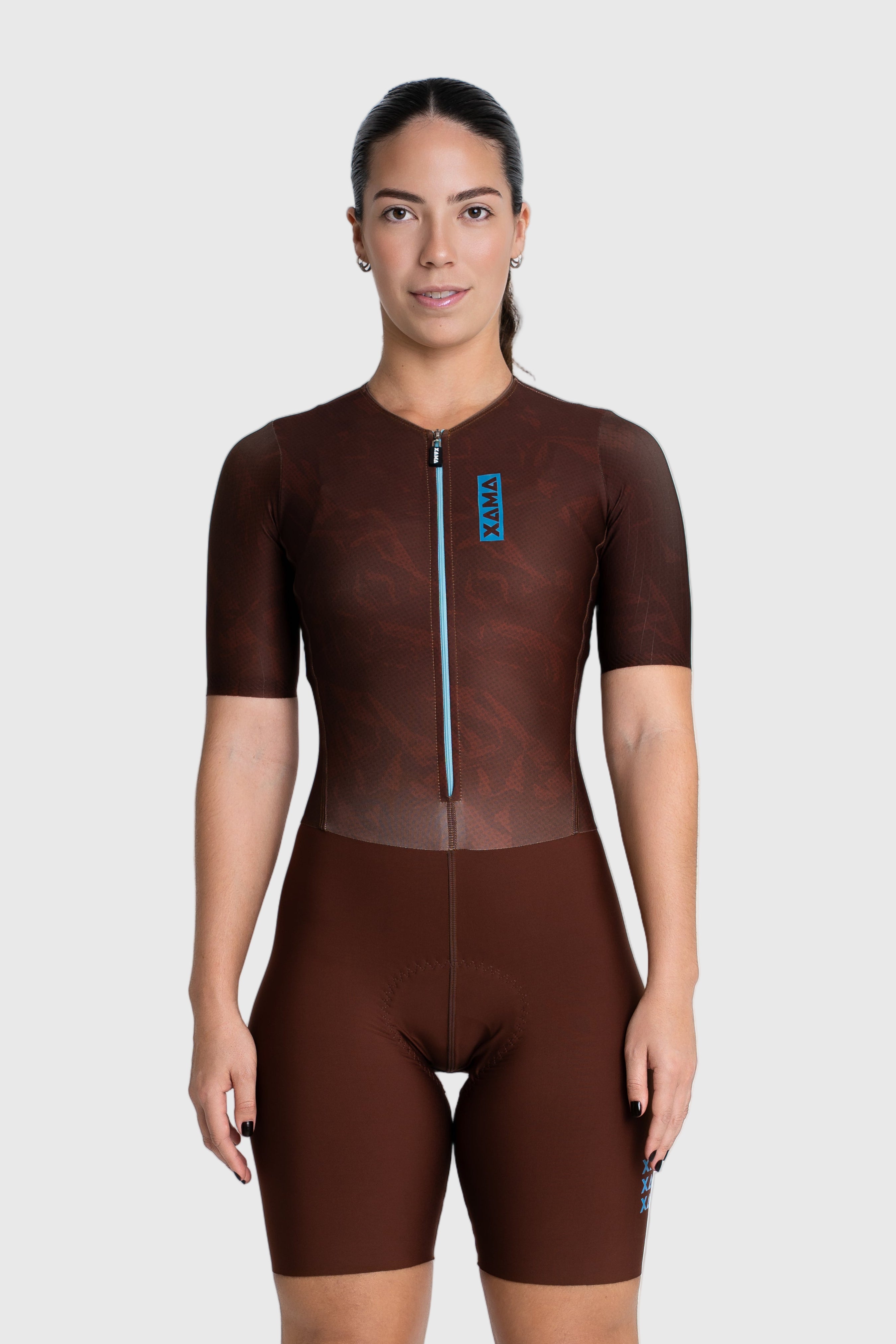 Person wearing a brown cycling suit on a white background