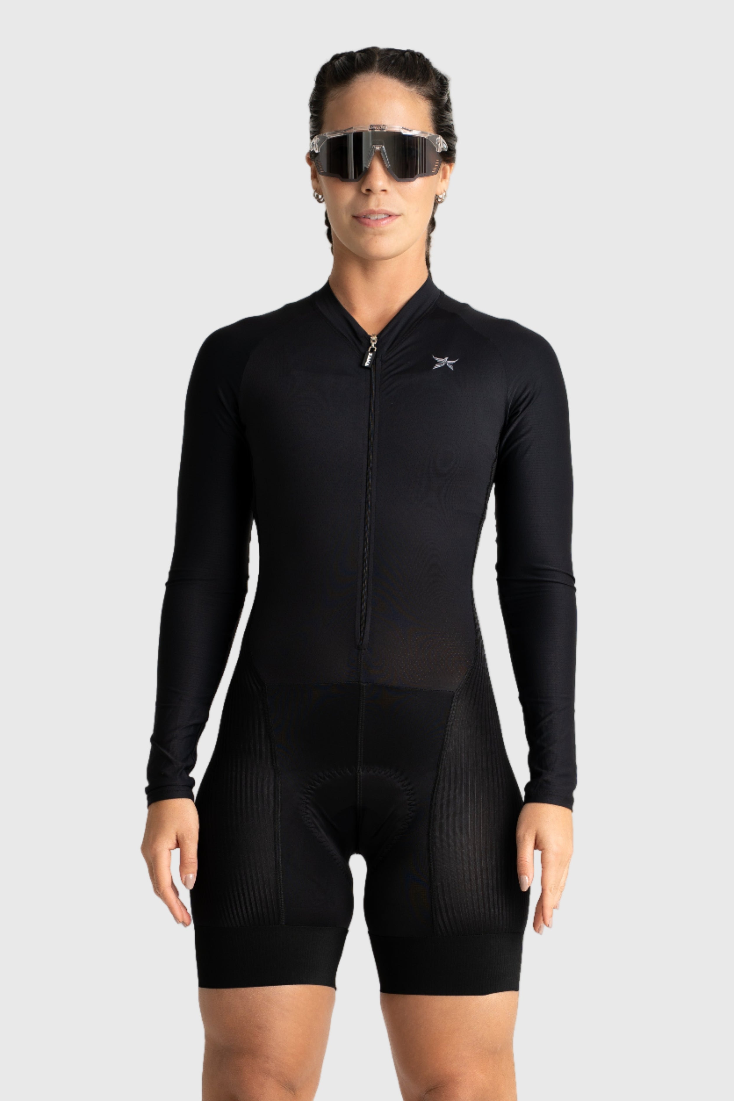 Person wearing a black cycling suit on a white background