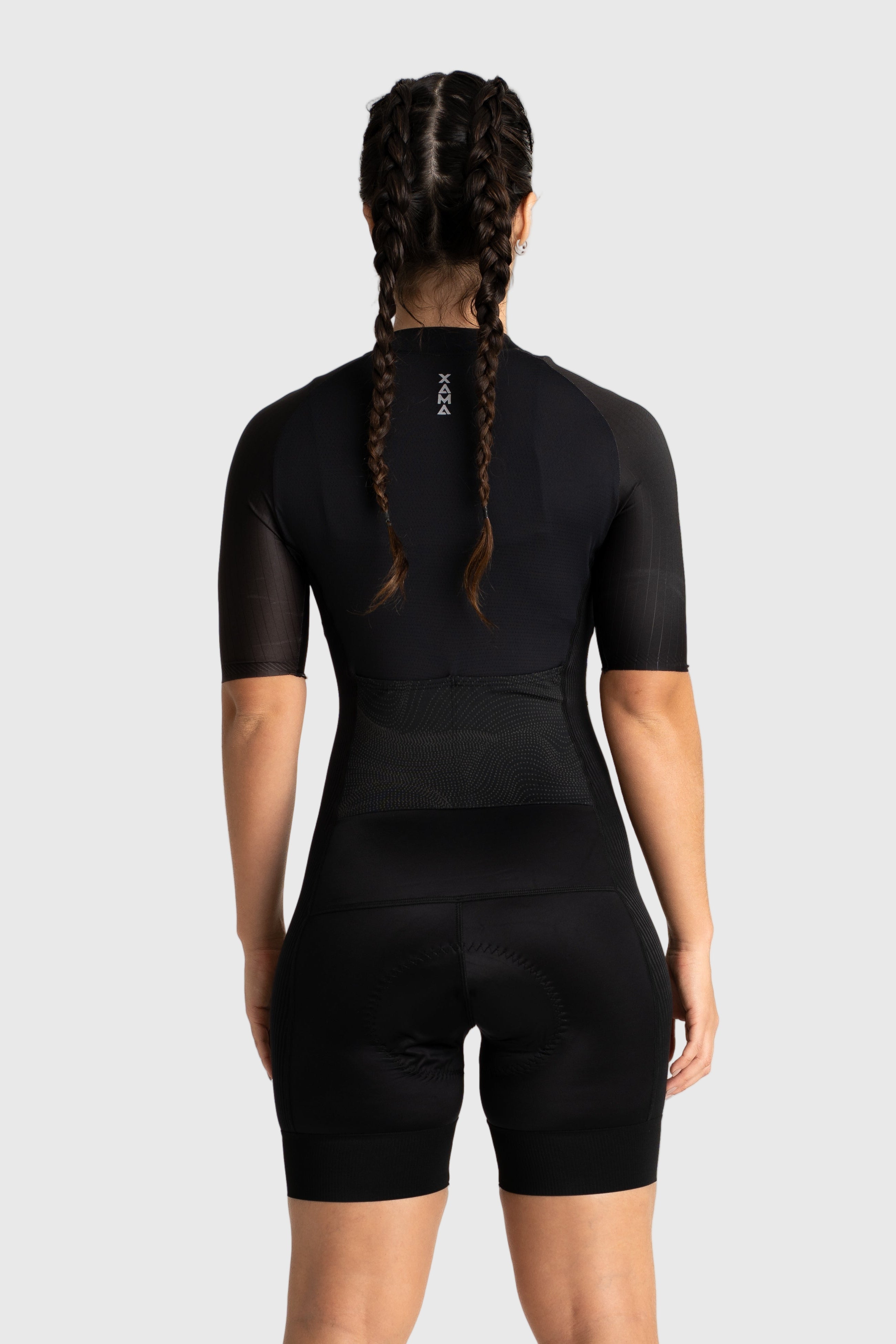 Person wearing a black cycling outfit on a white background