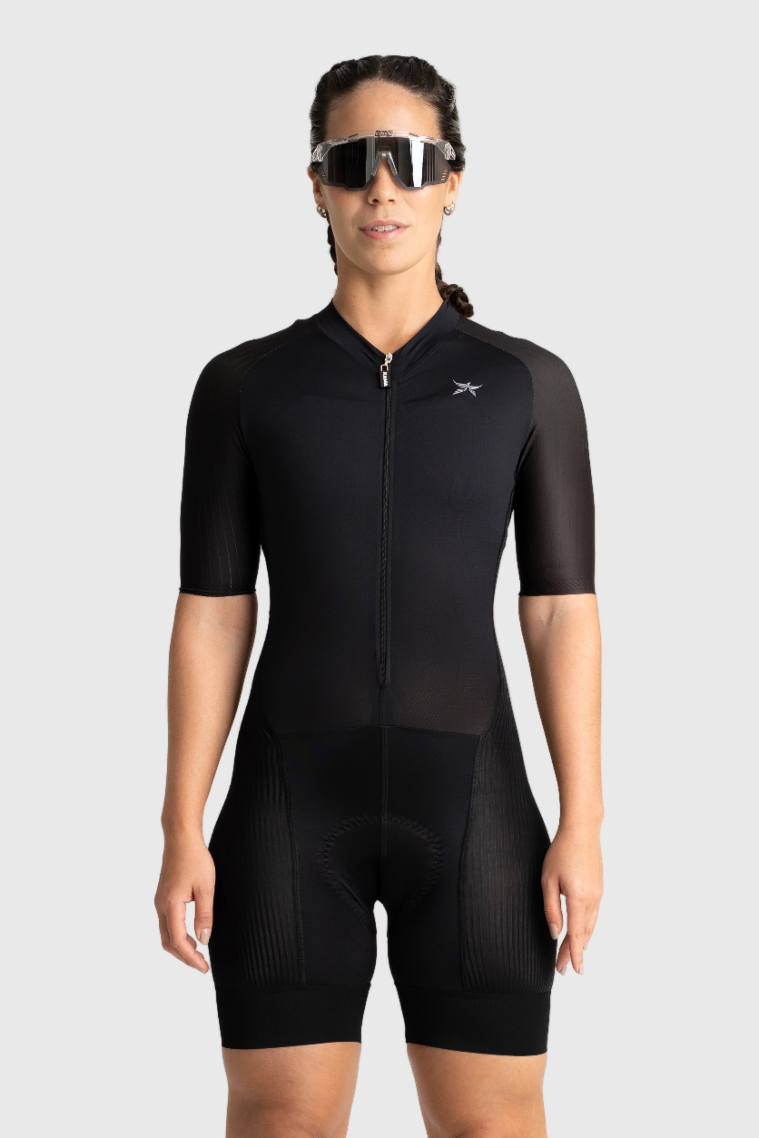 Person wearing a black cycling suit on a white background
