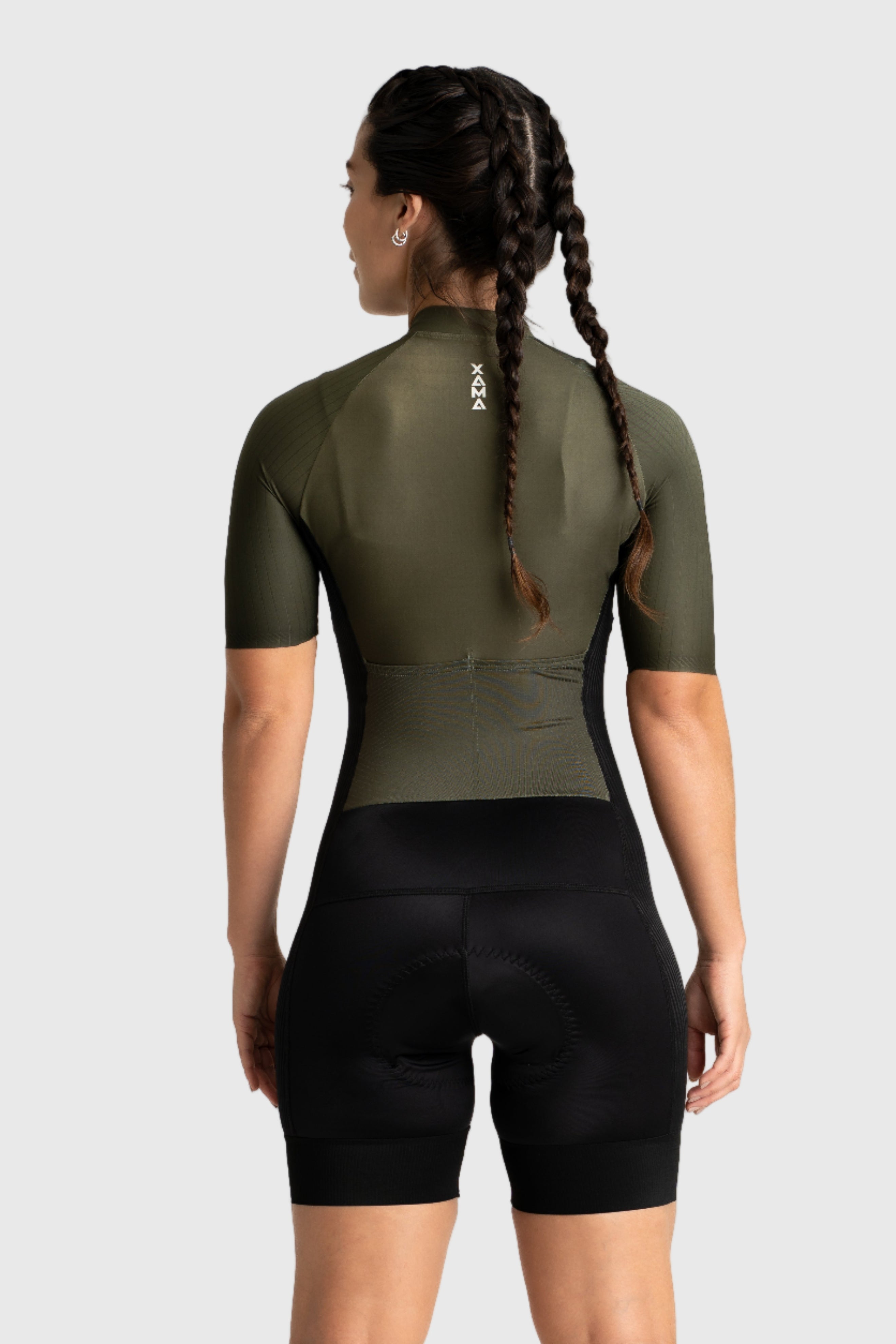 Person wearing a green cycling outfit on a white background