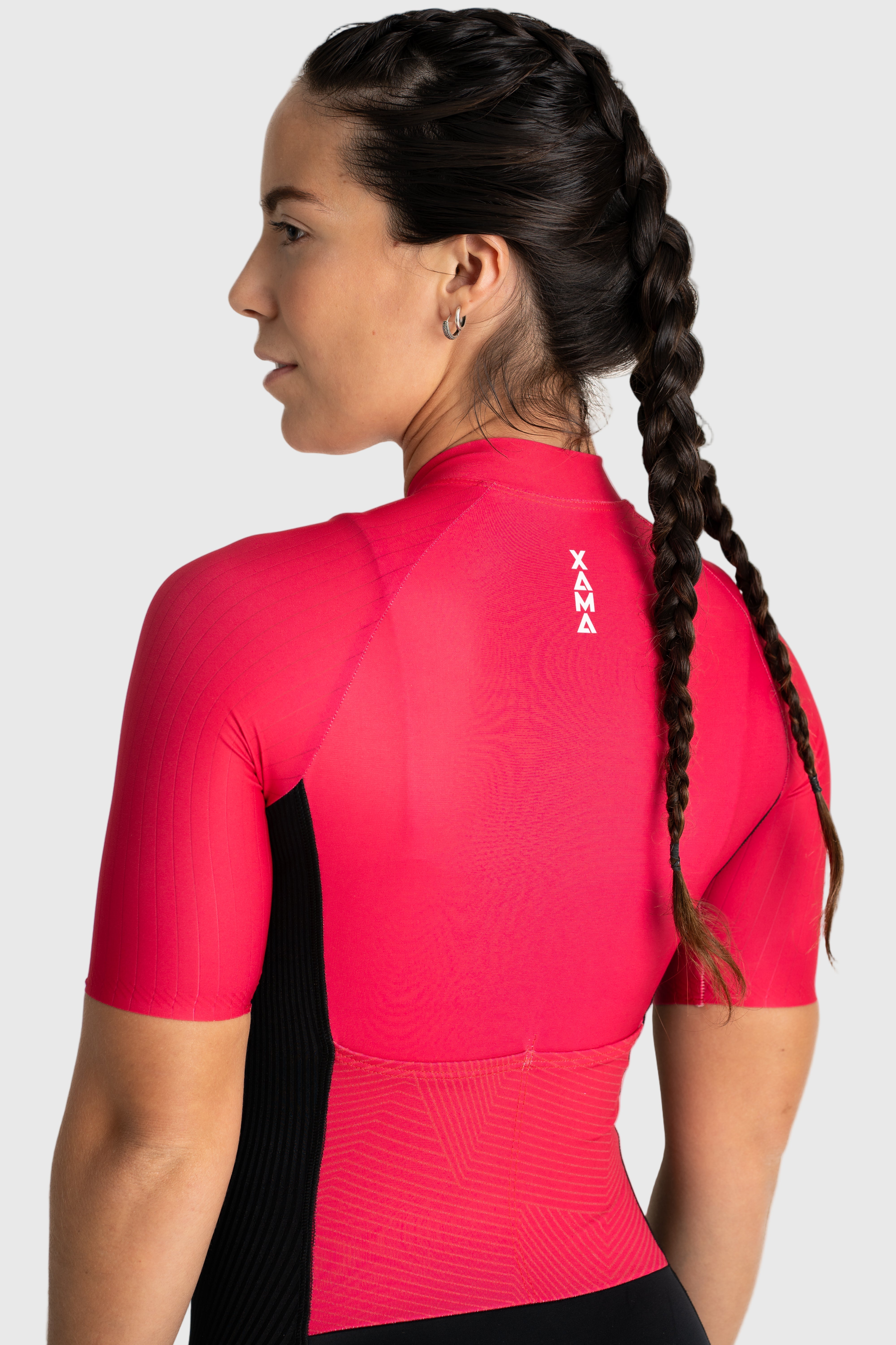 Person wearing a red athletic shirt with 'Xara' branding on a white background