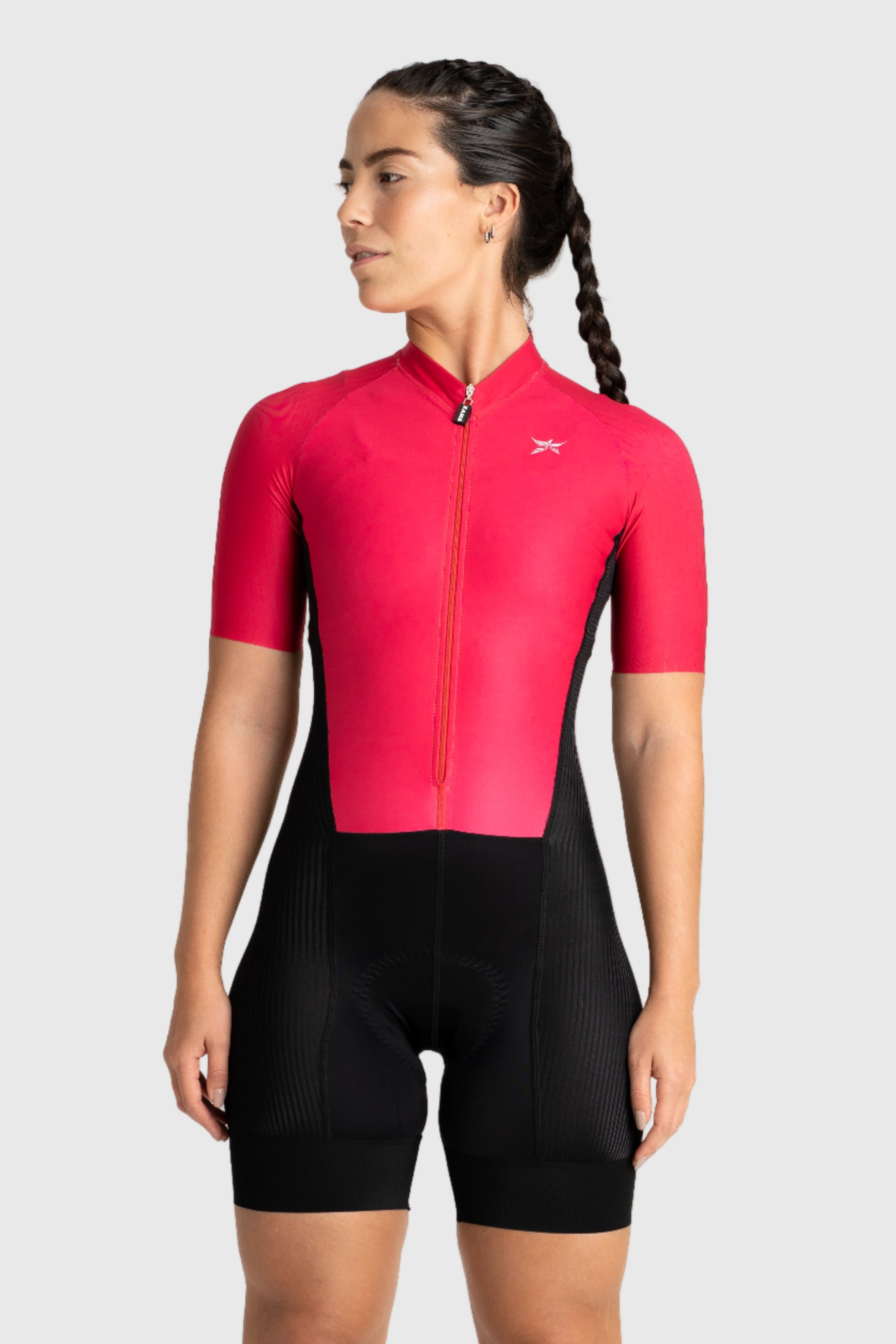 Person wearing a red cycling jersey and black shorts on a white background