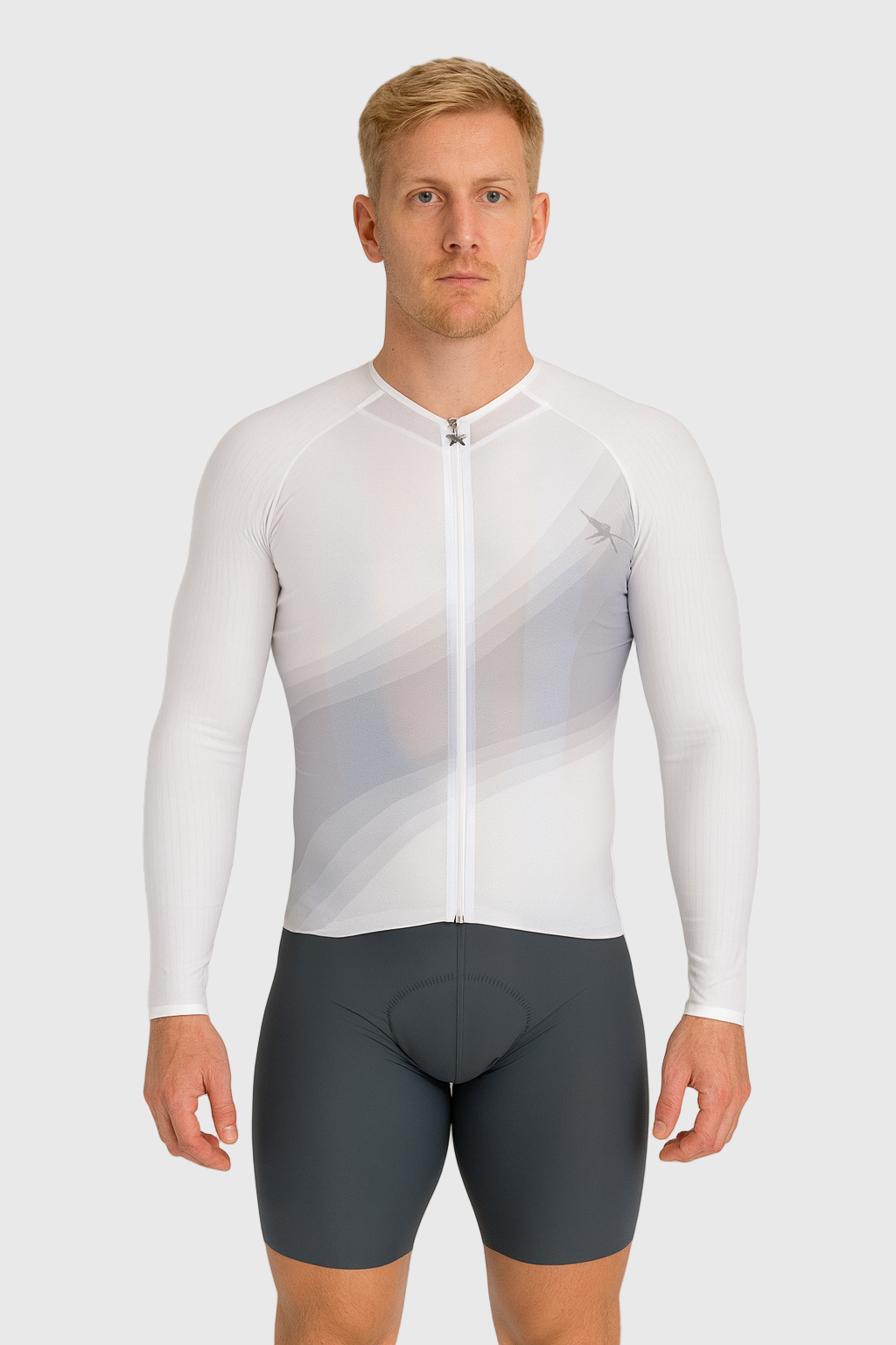 Man wearing a white cycling jersey and gray shorts on a plain background