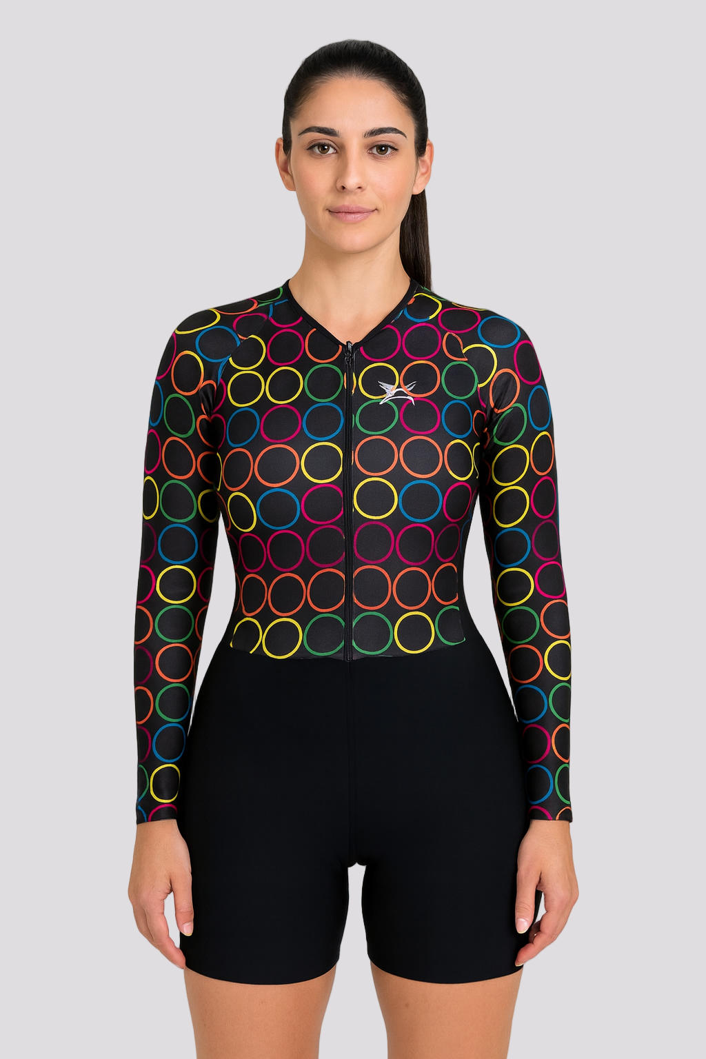 Woman wearing a black cycling outfit with colorful circle patterns on a white background