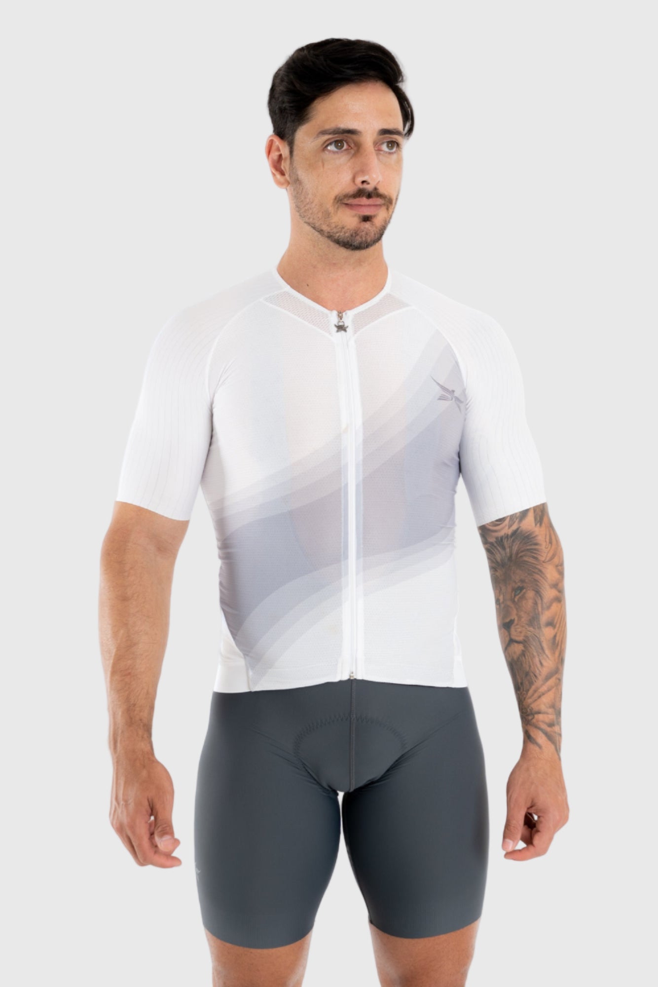 Man wearing a white cycling jersey and gray shorts on a white background