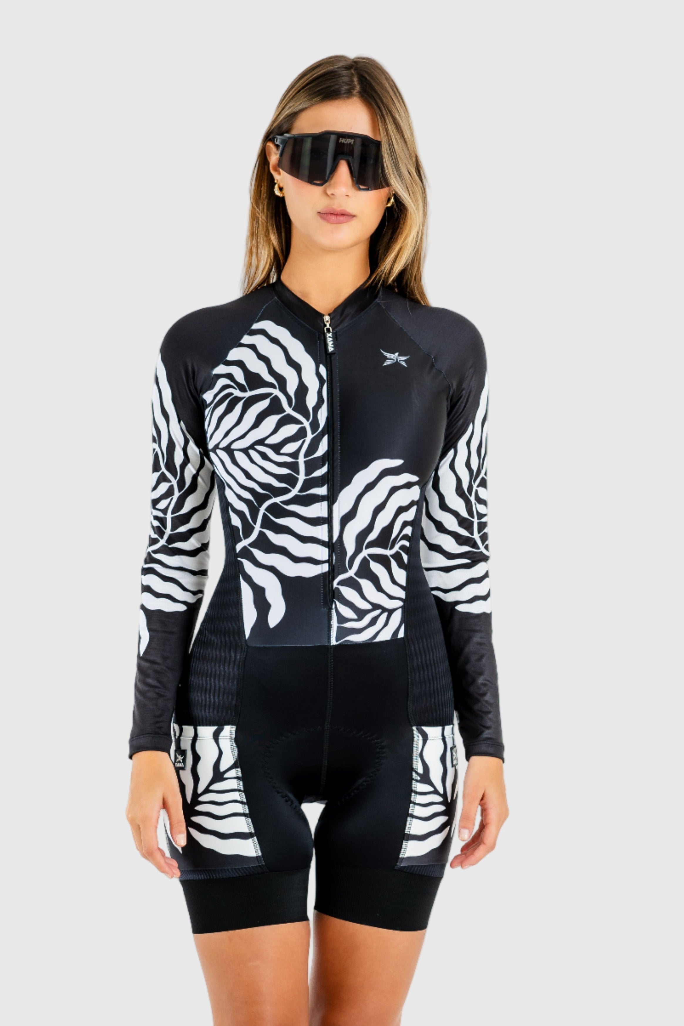 Woman wearing a black and white cycling outfit on a white background