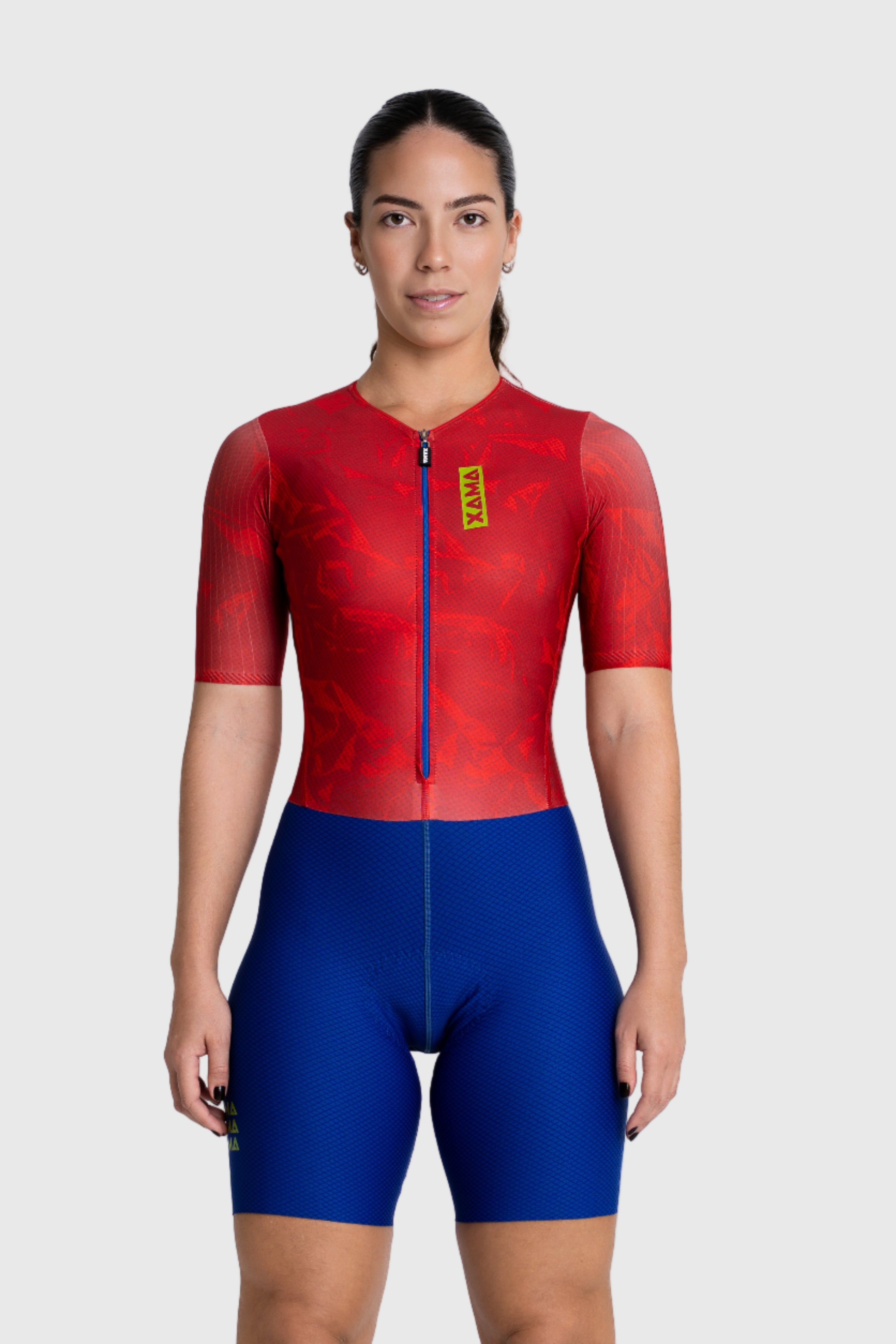 Person wearing a red and blue cycling suit on a white background
