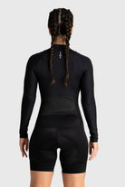 Person wearing a black wetsuit on a white background