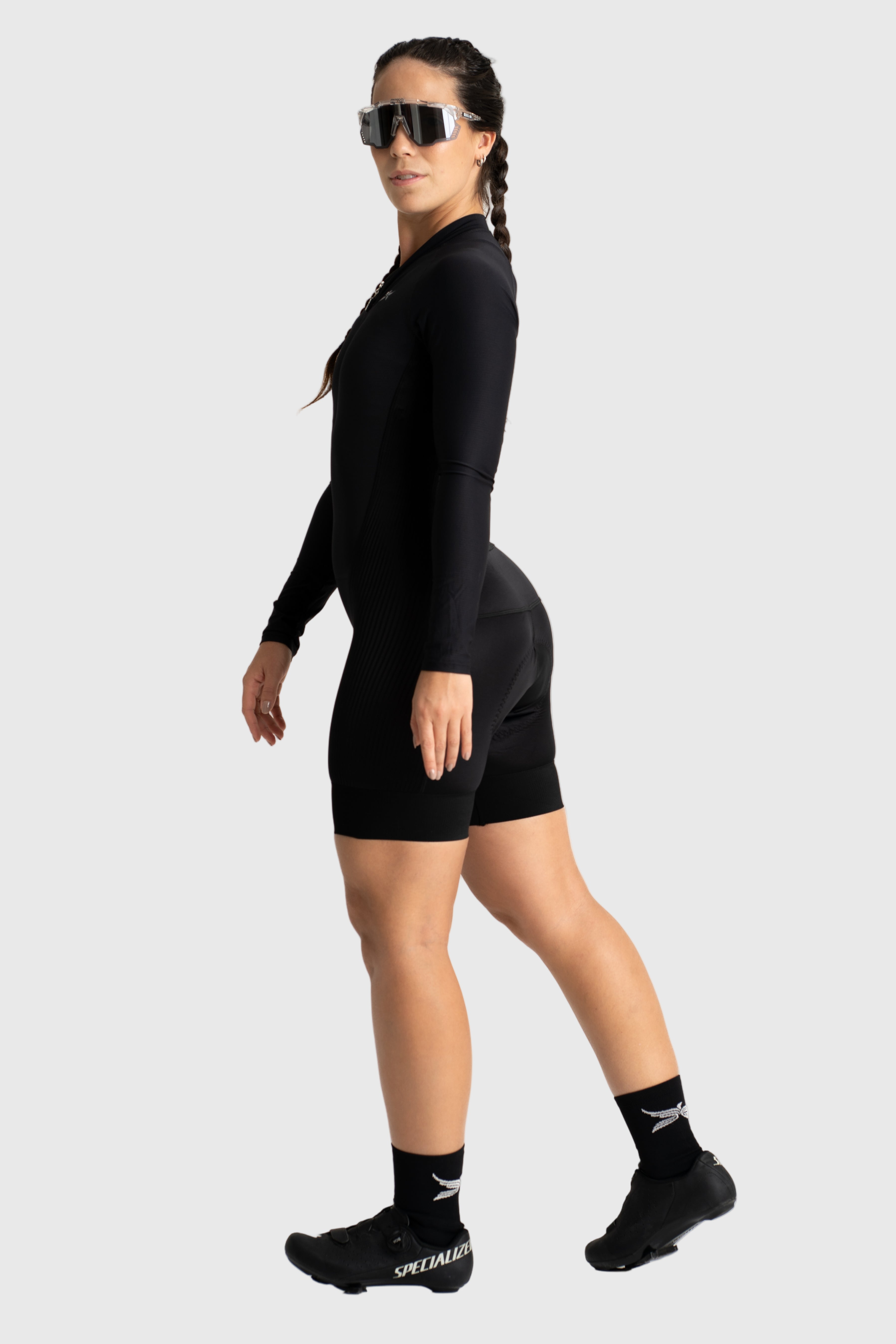 Person wearing a black athletic outfit with sunglasses on a white background