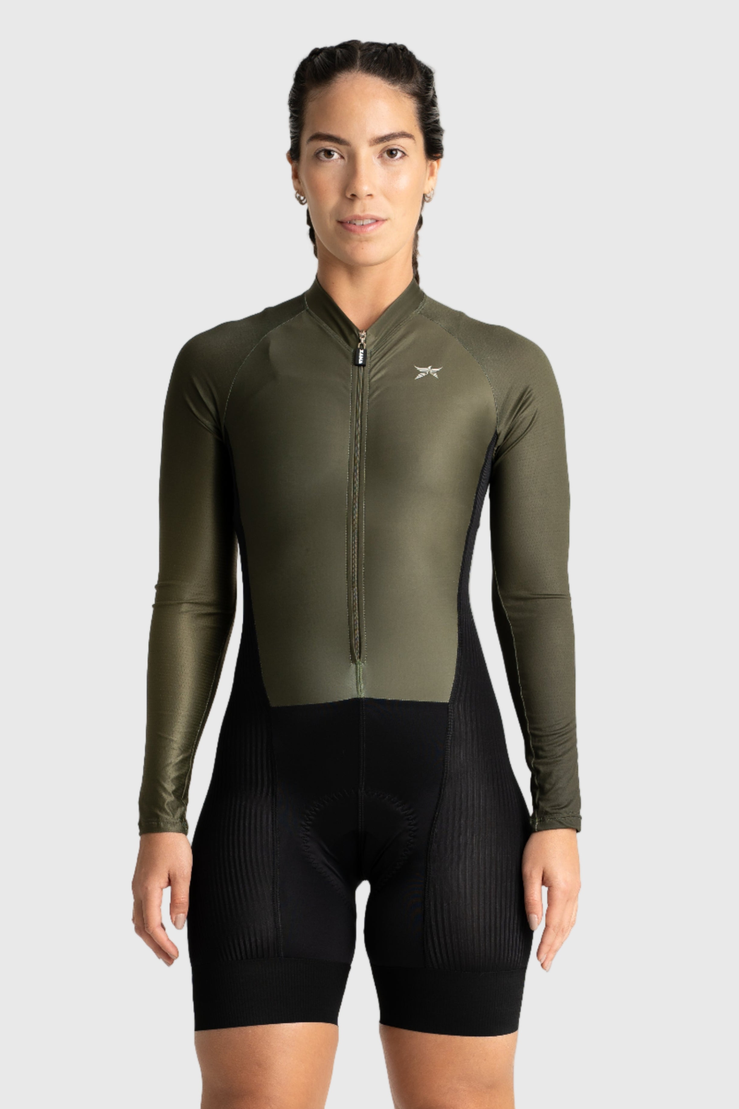 Person wearing a green cycling suit on a white background