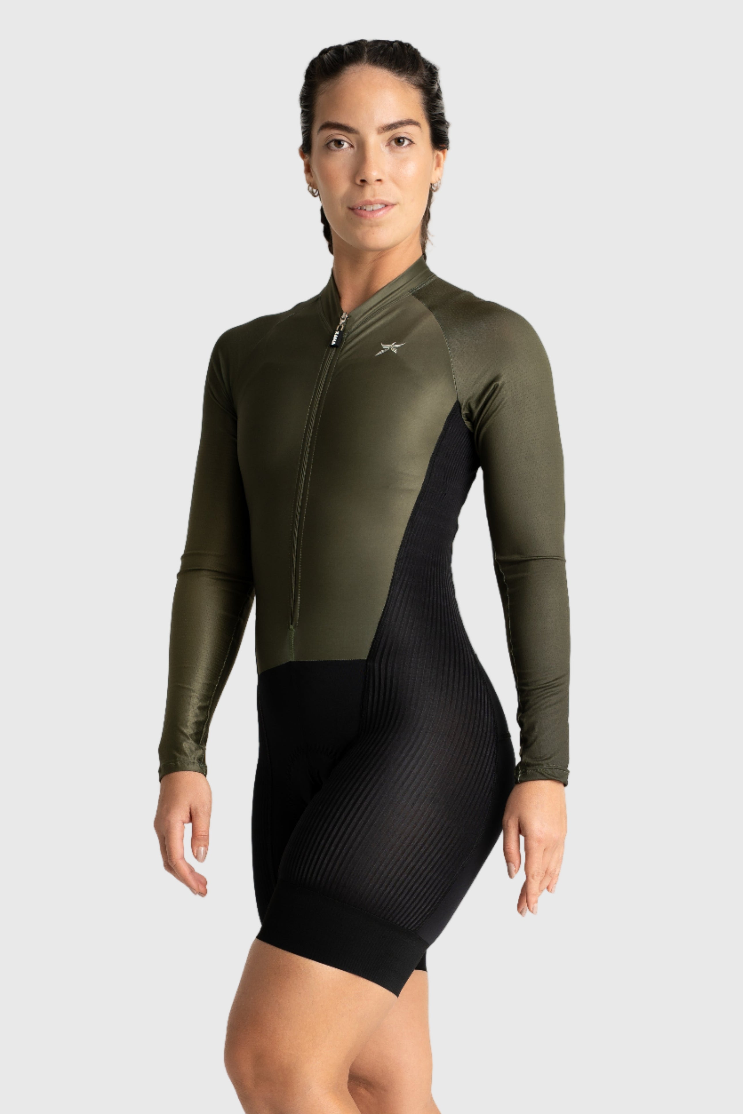Woman wearing a green and black wetsuit on a white background