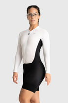 Person wearing a white and black cycling suit on a white background