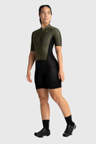 Person wearing a green and black cycling suit on a white background