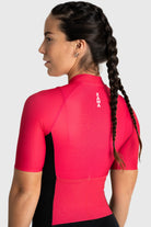 Person wearing a red athletic shirt with 'Xara' branding on a white background