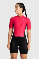 Person wearing a red cycling jersey and black shorts on a white background