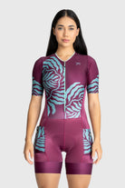 Woman wearing a purple and blue patterned athletic outfit on a white background