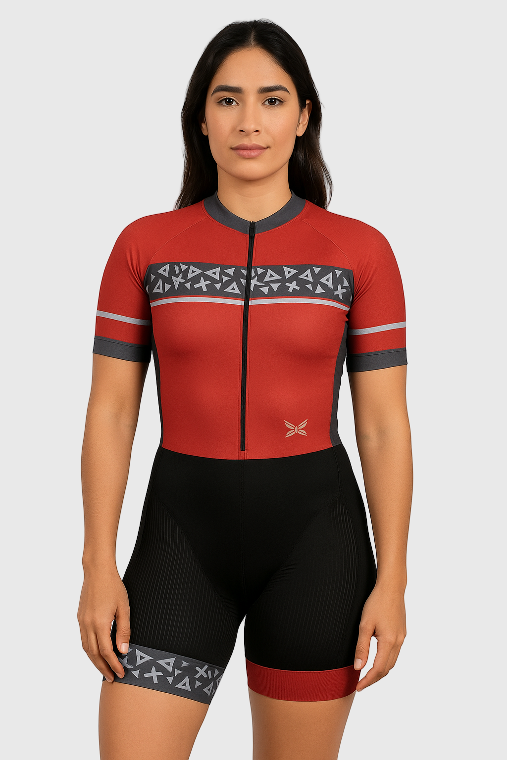 Woman wearing a red and black cycling outfit with geometric patterns on a light gray background