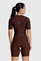 Person wearing a brown wetsuit on a white background