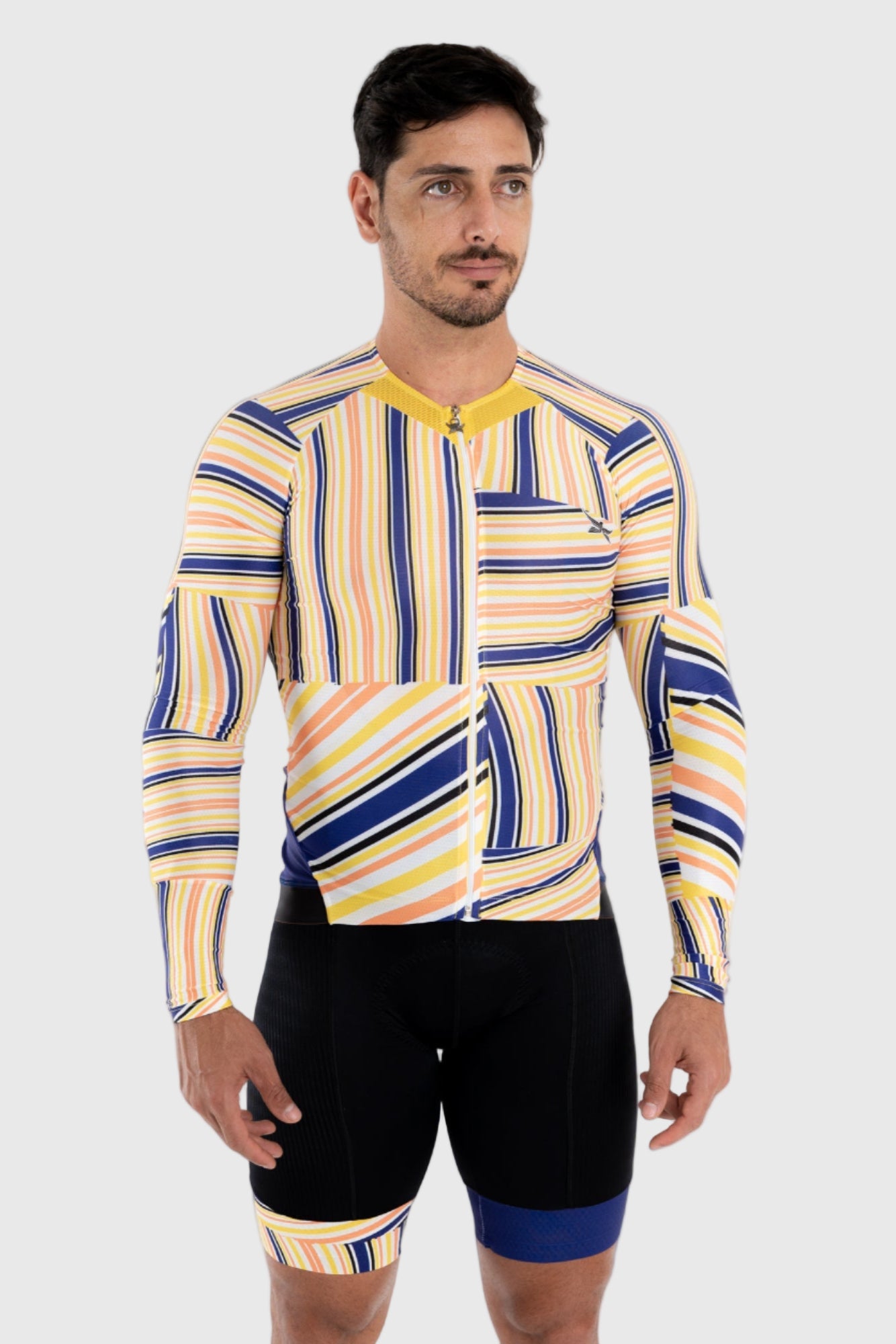 A man wearing a multicolored striped cycling top and black cycling shorts.