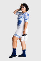 Person wearing a blue and white patterned outfit with a plain background