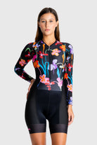 Woman wearing a colorful floral cycling outfit on a white background