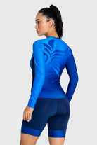 Woman wearing a blue athletic outfit with a white background
