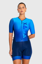 Person wearing a blue and black Xama triathlon suit on a white background