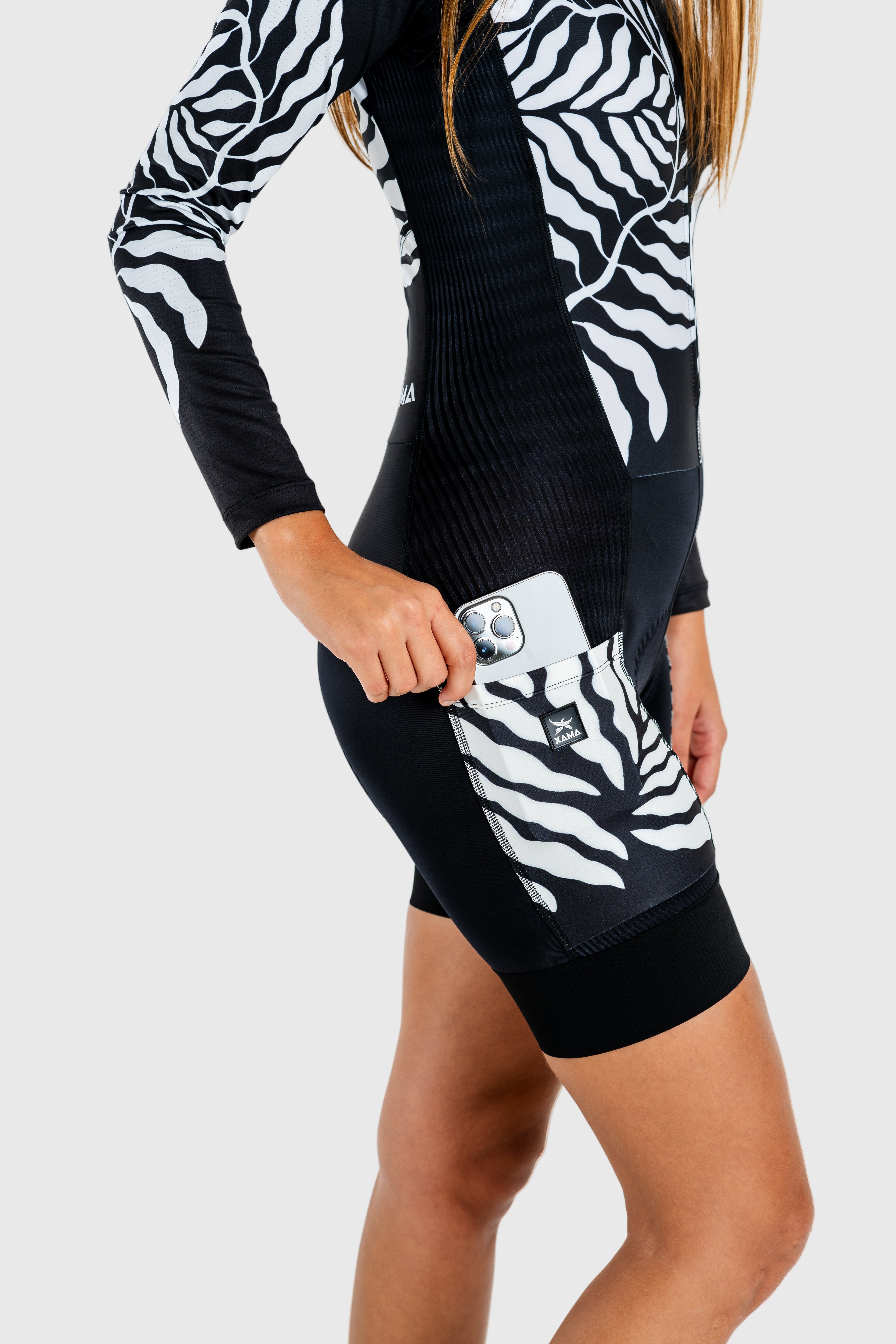 Black and white zebra-patterned outfit with a visible brand logo on a white background