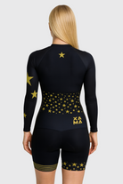 Black athletic outfit with gold star patterns on a white background