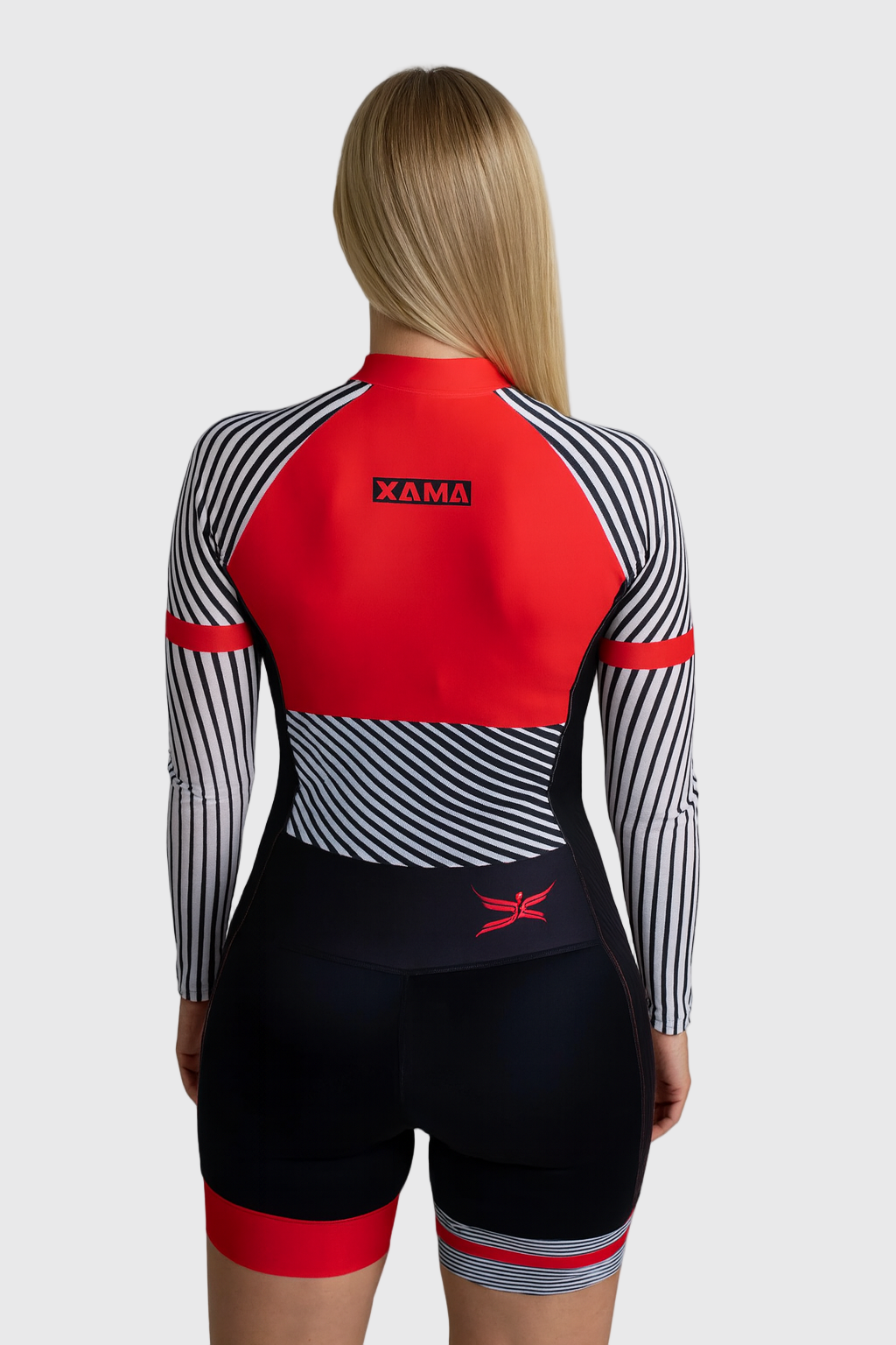 Person wearing a red and black cycling outfit with XAMA branding on a light gray background