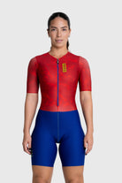 Person wearing a red and blue cycling suit on a white background