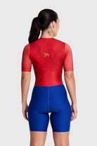 Person wearing a red and blue cycling suit on a white background