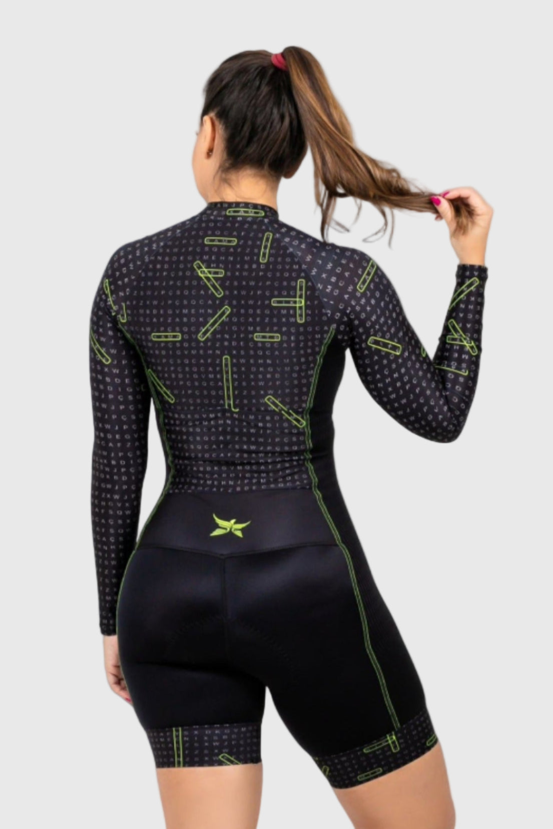 Person wearing a black and green cycling outfit on a white background